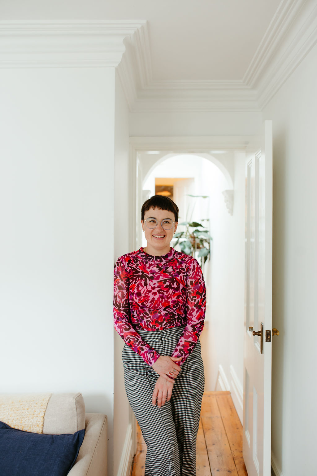 Chauncey Sjostedt standing in a bright hallway doorway with hands loosely clasped