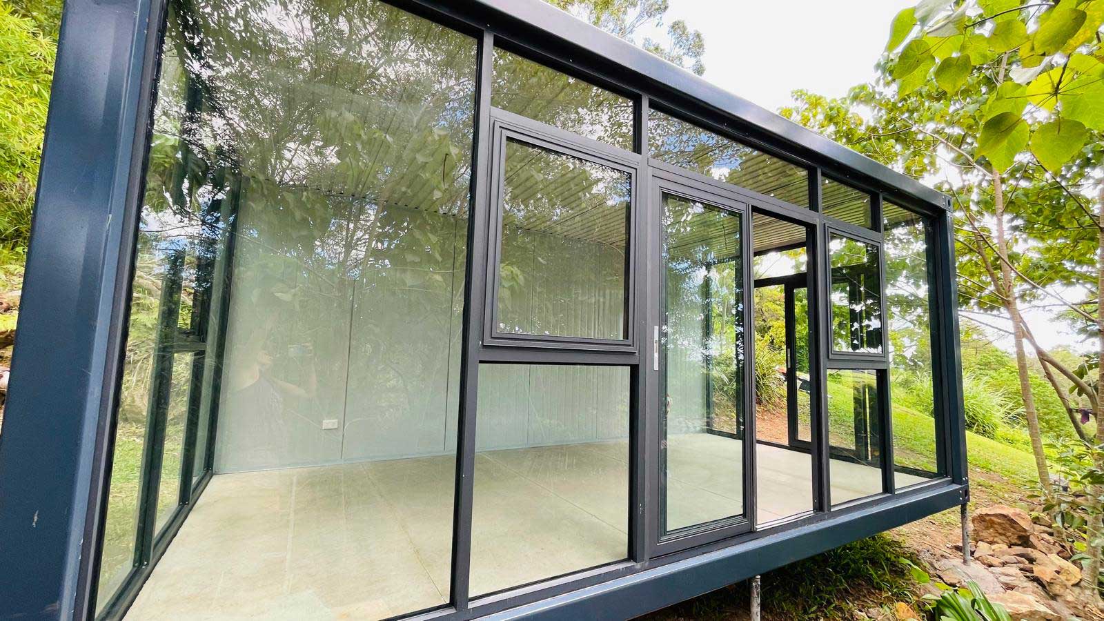 Prefab glass office pod exterior showing material quality and framing